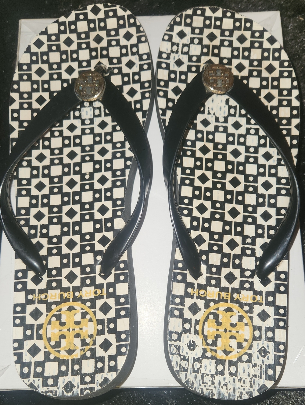 Tory Burch Black and White Geometric Logo Flip Flops with Gold Medallion